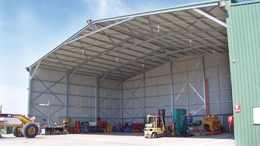 A Large Metal Building With A Blue Sky In The Background — More Than Garages Pty Ltd–Ranbuild Tamworth in Taminda, NSW