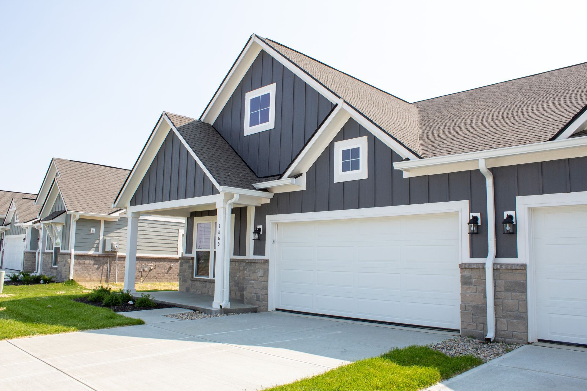 Outside of a duplex. Gray/blue exterior with white trim