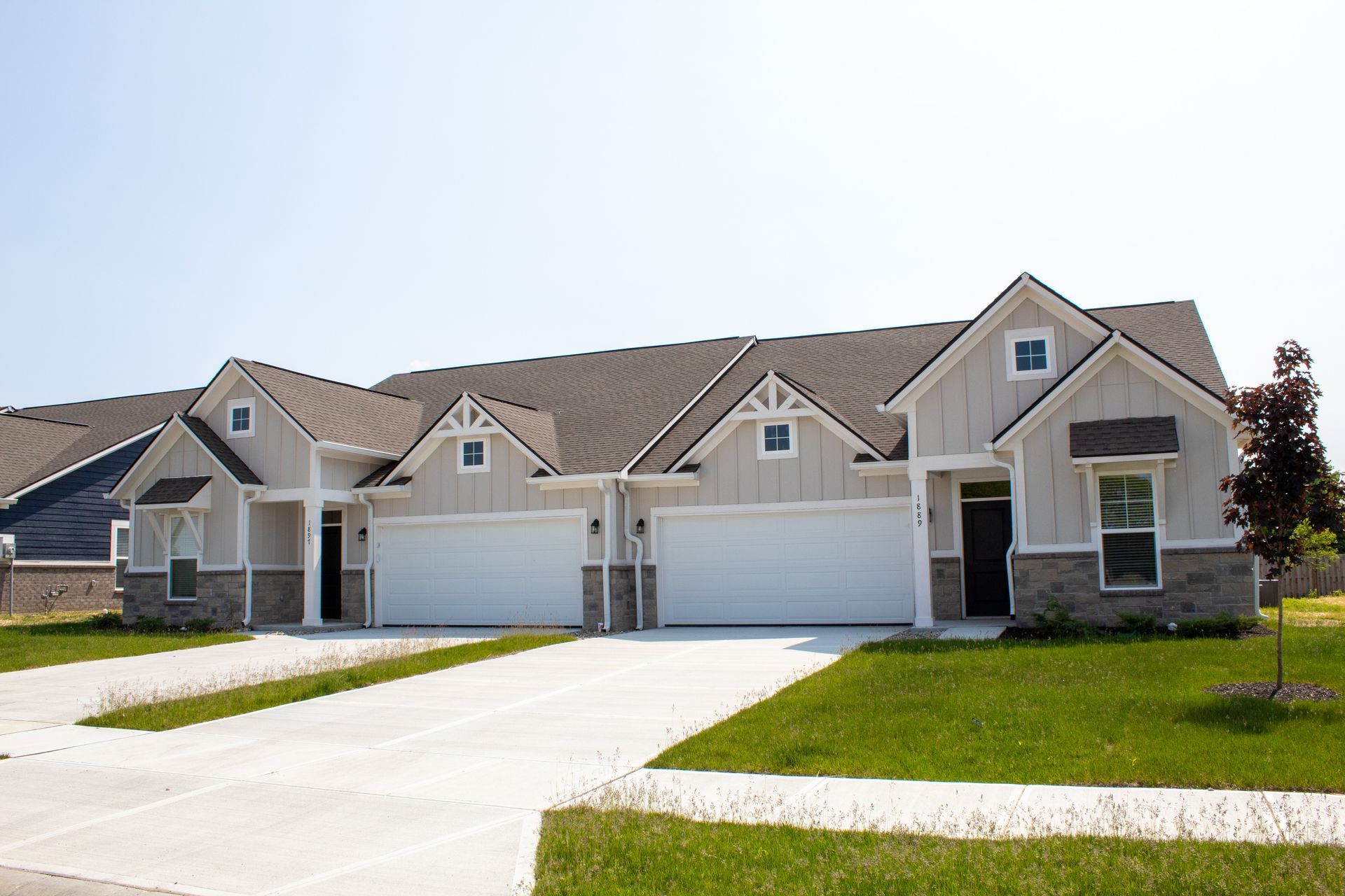 Outside of a duplex. Cream colored siding
