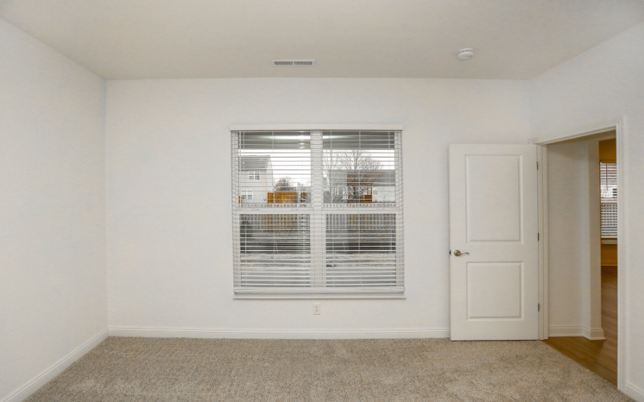 Bedroom with carpeting and one window