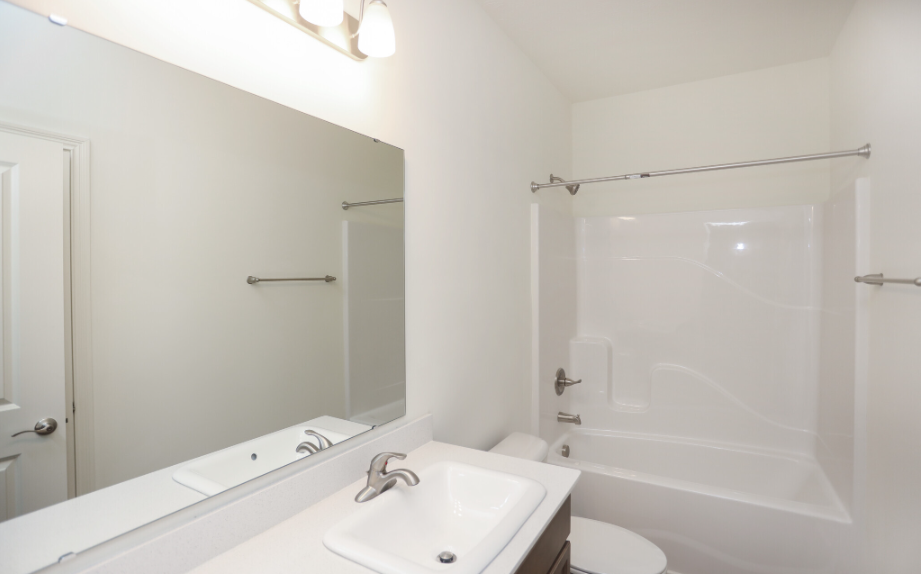 Bathroom featuring a bathtub, shower, and vanity with mirror