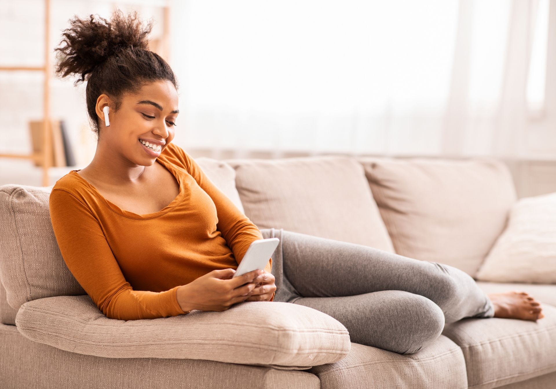 Woman using phone and smiling