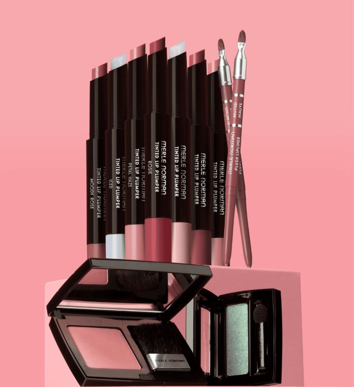 Cosmetics arranged on a white surface, including lipsticks, eye shadows, and perfume bottles.