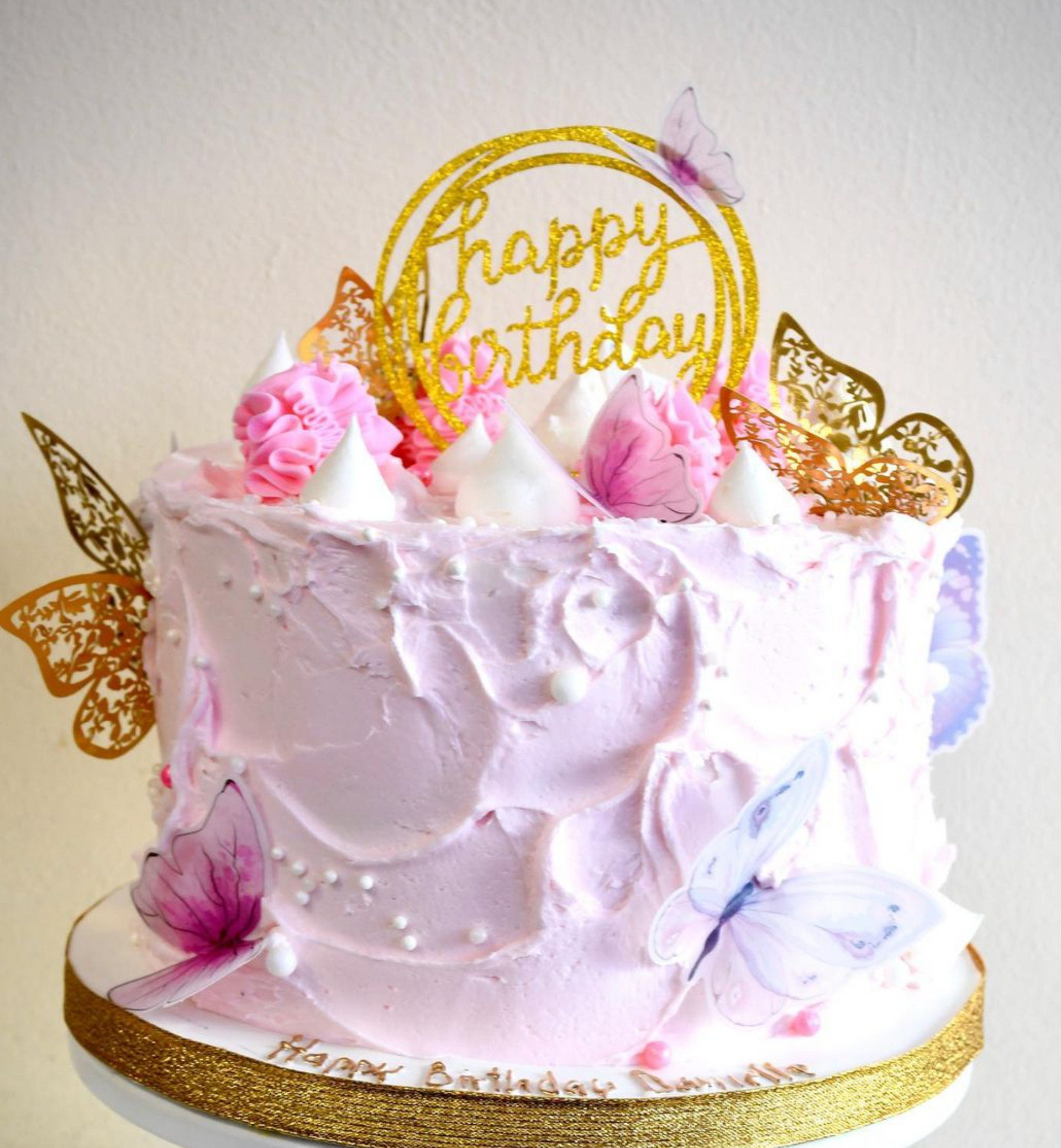 A cake with a happy birthday topper on top