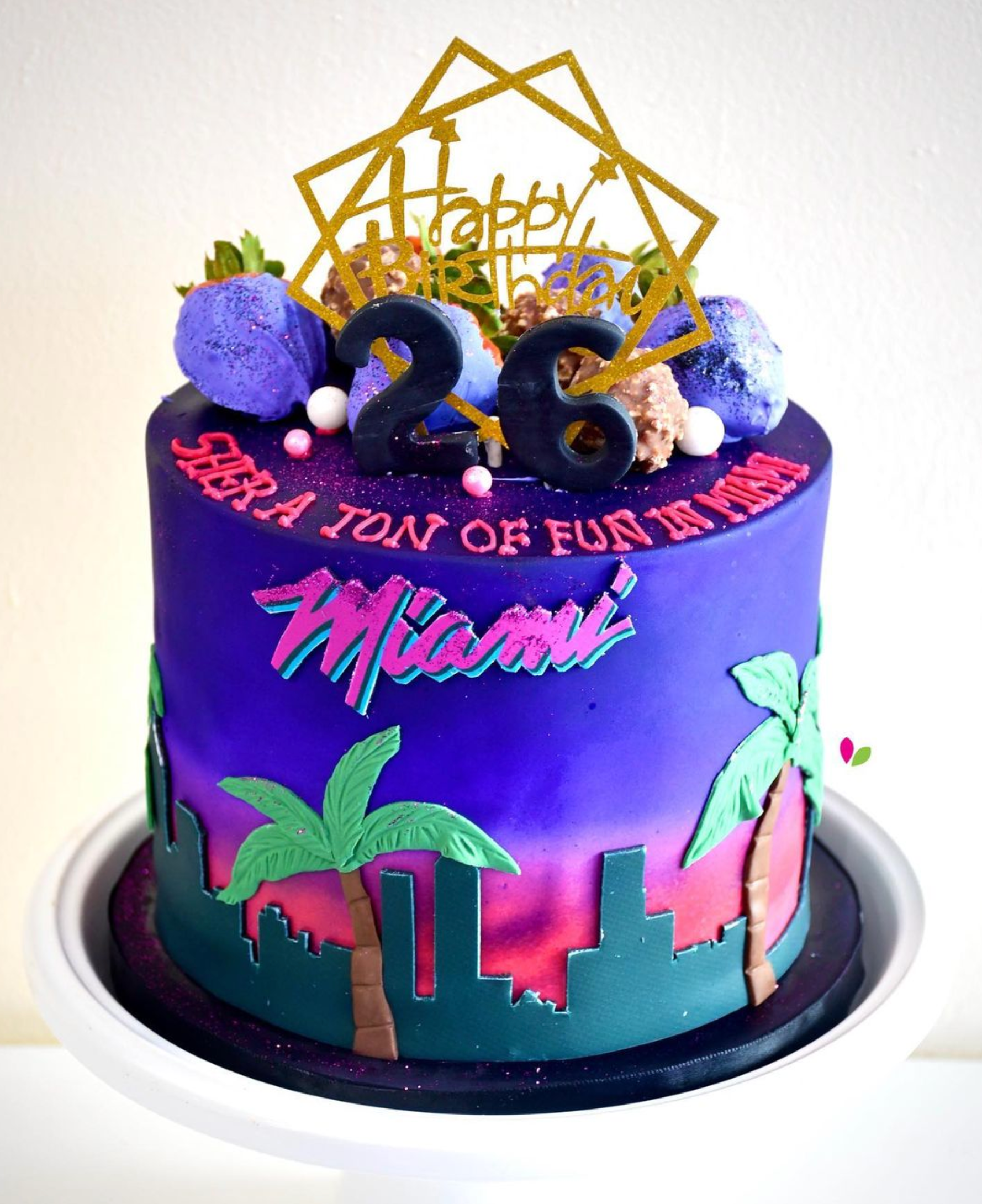 A purple cake with the number 26 on top