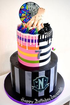 A birthday cake with a spider on top of it