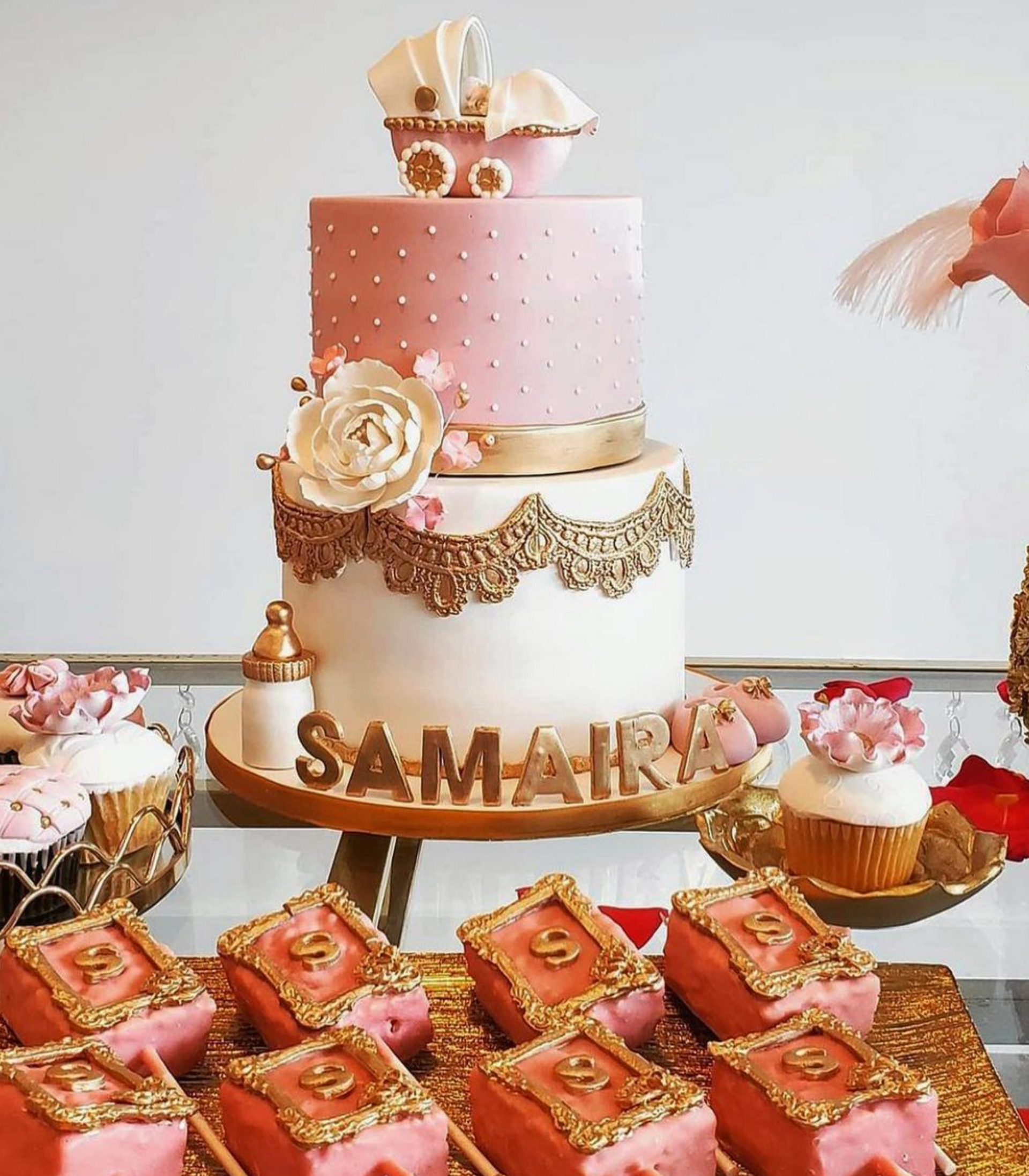A pink and white cake with the name samara on it