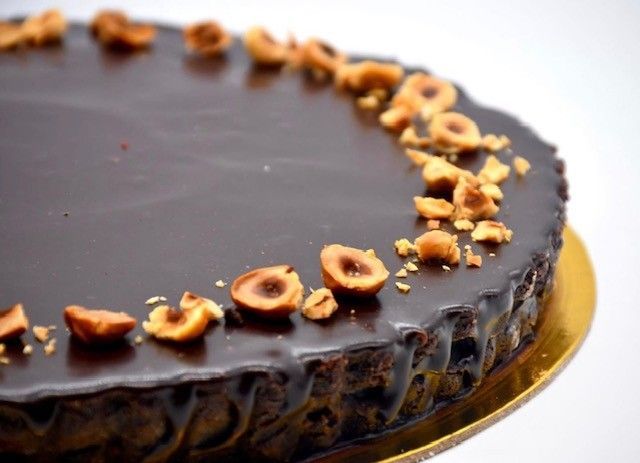 A chocolate cake with nuts on top of it