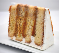 A slice of cake is sitting on a white plate.