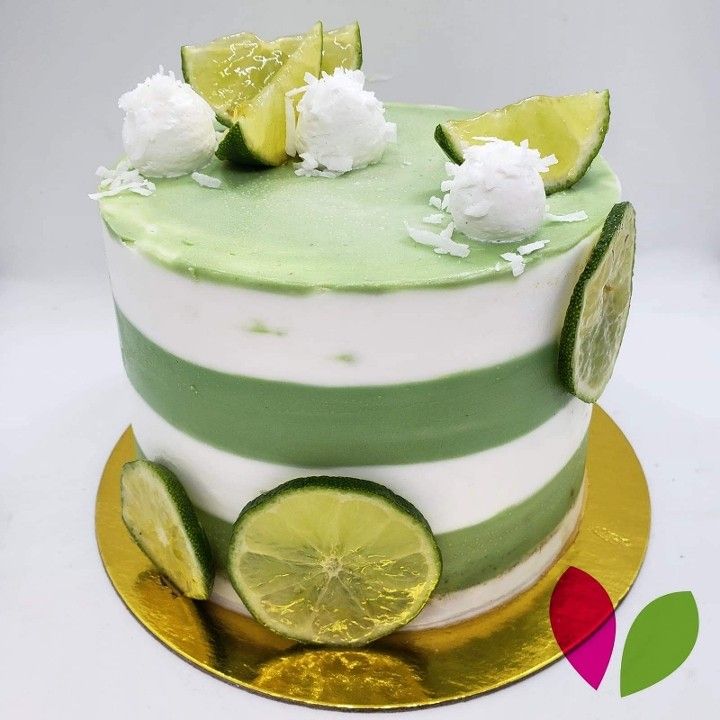 A green and white striped cake with lime slices on top