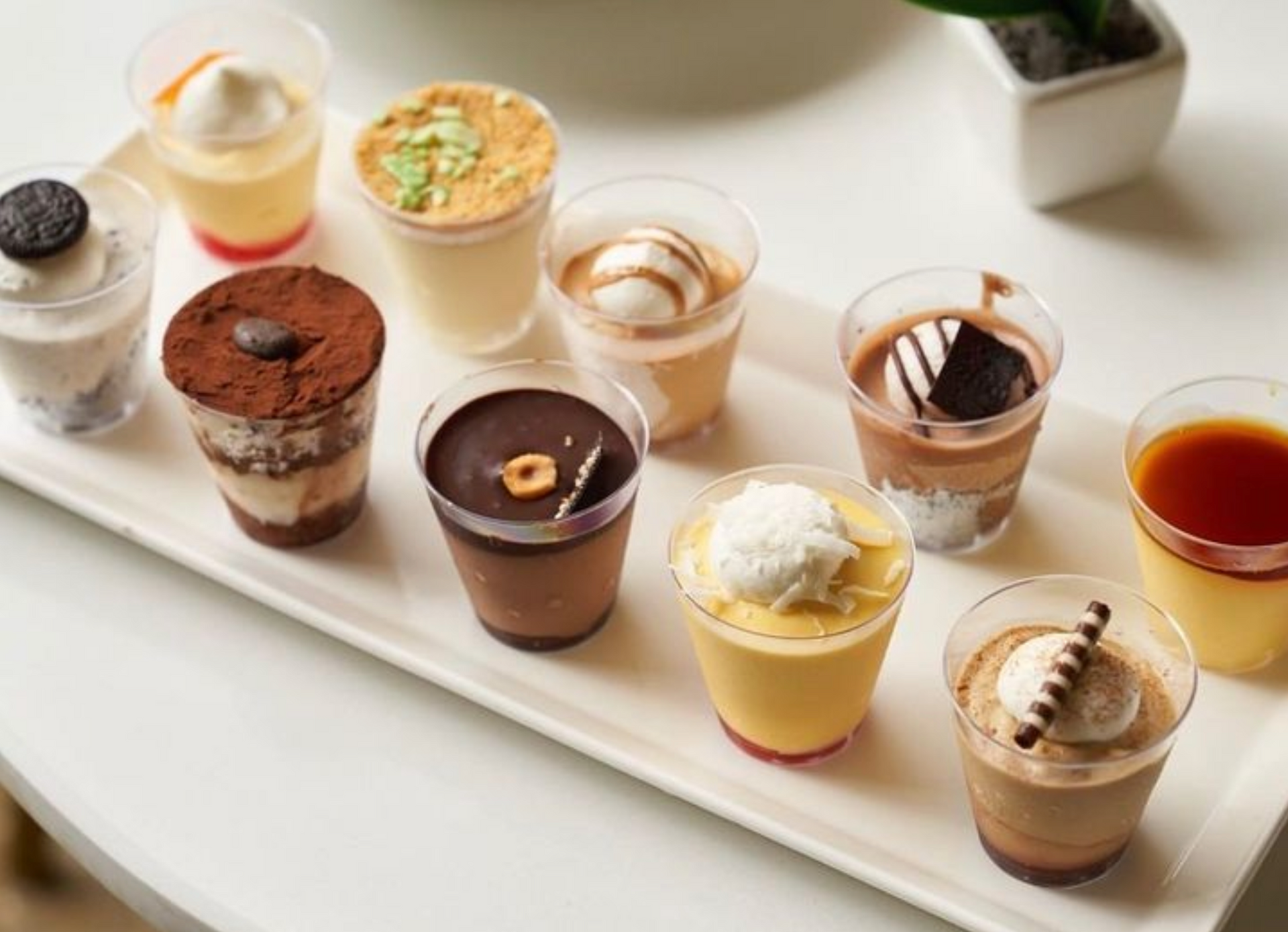 A white plate topped with a variety of desserts.