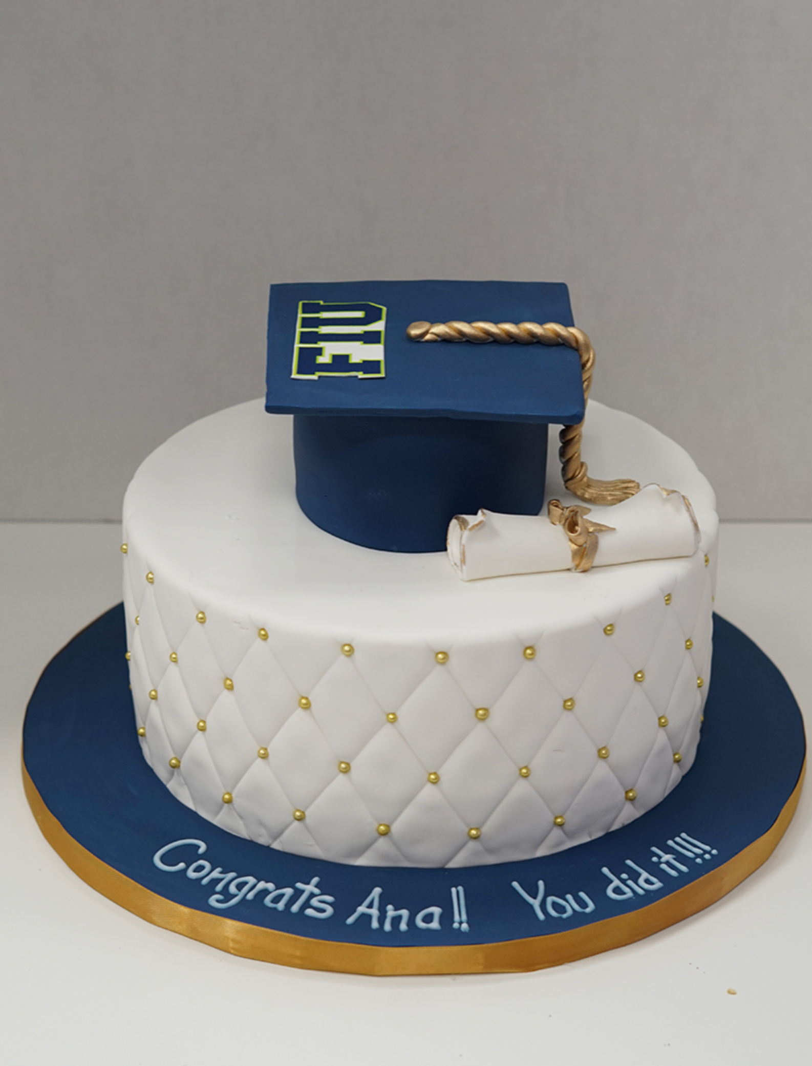 A cake with a graduation cap and diploma on it