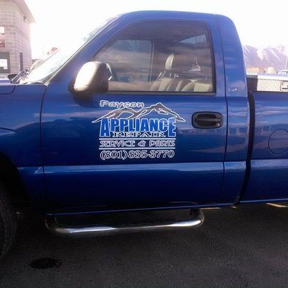 Blue car parked in parking lot by payson utah appliance repair.