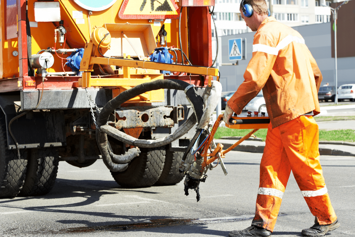 workers in reflective vests using shovels during construction