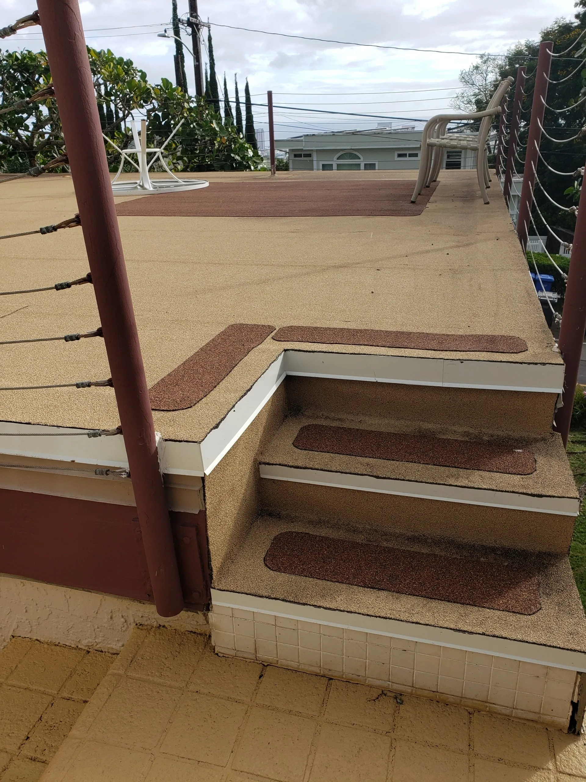 A deck with stairs leading up to it and a railing.