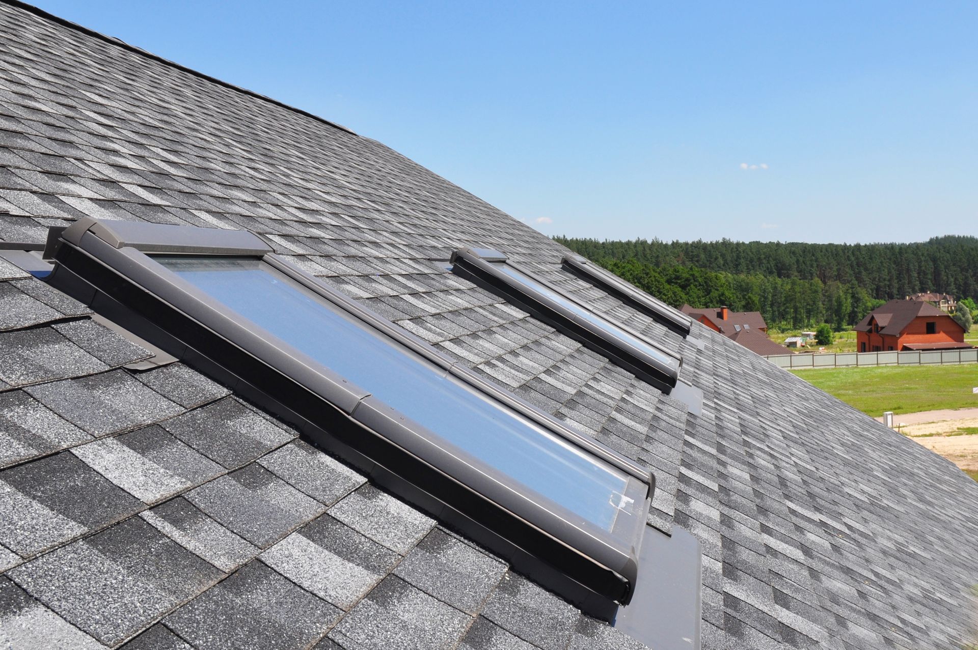 There are two skylights on the roof of a house.
