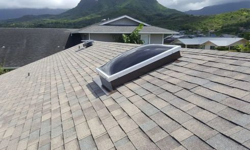 A roof with a skylight and mountains in the background. A roof with a skylight and mountains in the background.