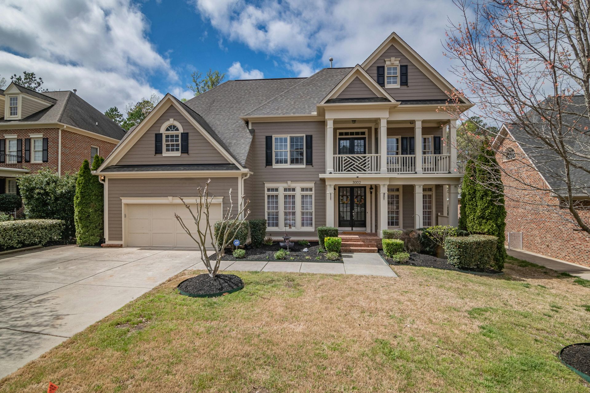 A large house with a lot of windows and a garage