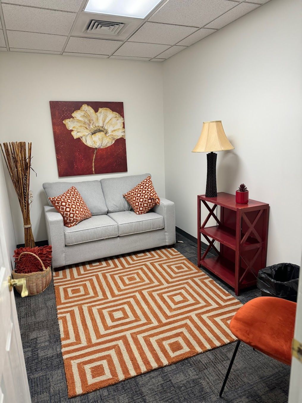 A living room with a couch and a rug