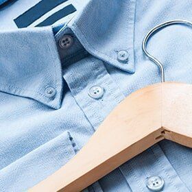 Blue Shirt with a Wooden Hanger - Jacksonville, FL - A Greener Cleaner