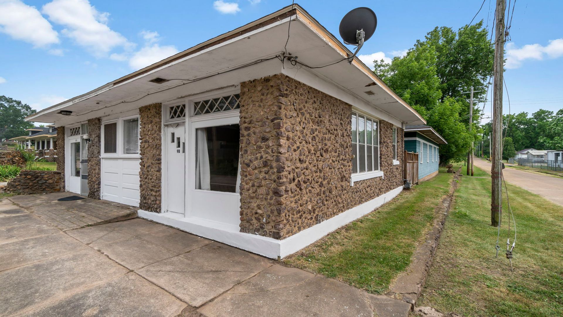 a small brick house with a satellite dish on the roof .