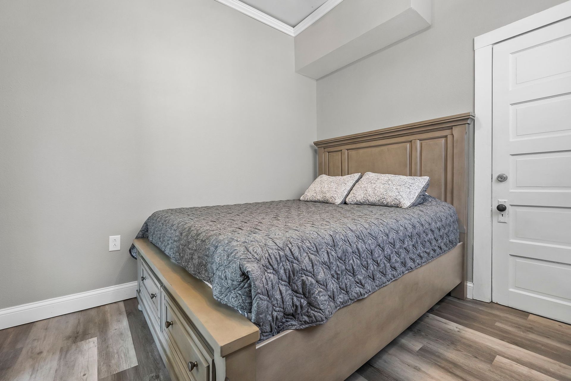 a bedroom with a king size bed and a door .