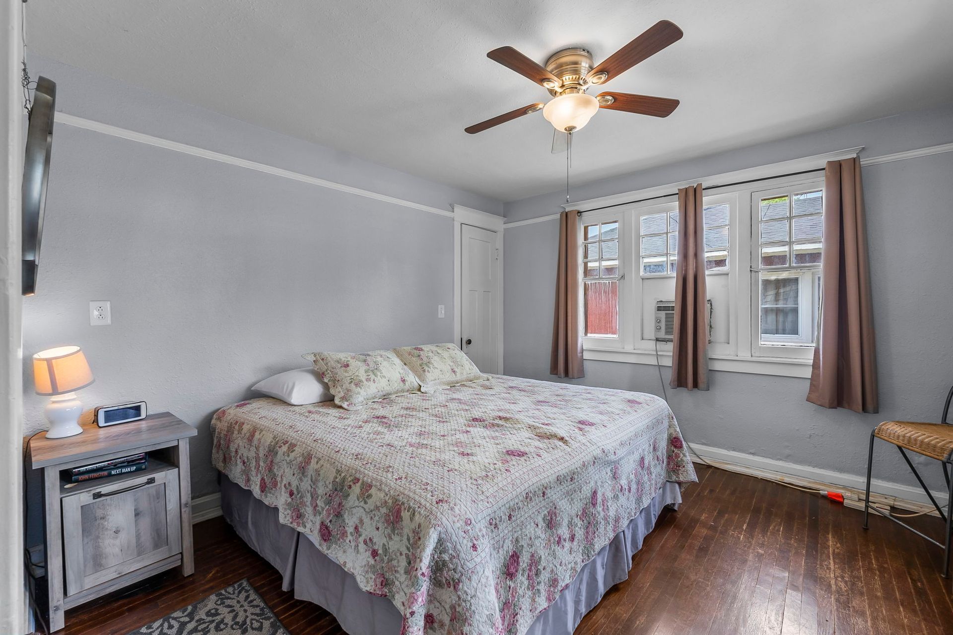 a bedroom with a large bed and a ceiling fan .