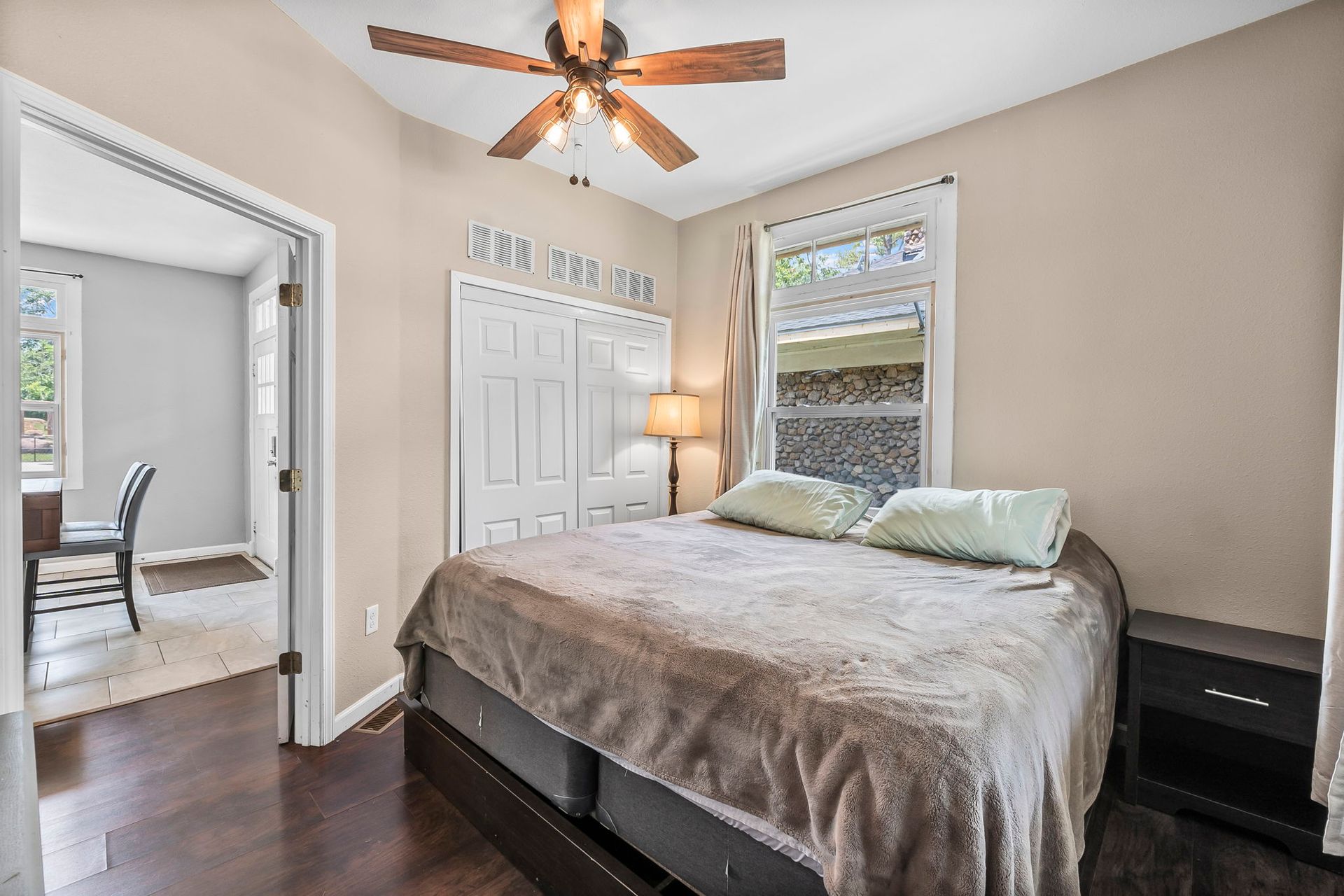 a bedroom with a bed and a ceiling fan .