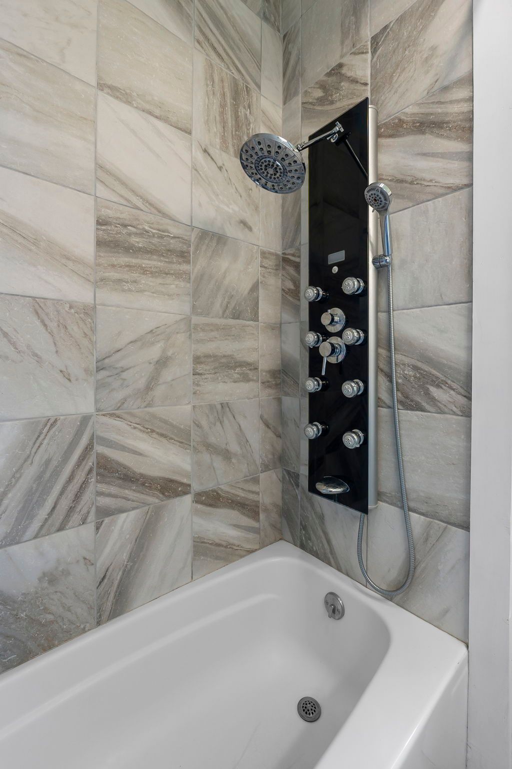 a bathroom with a bathtub and a shower .