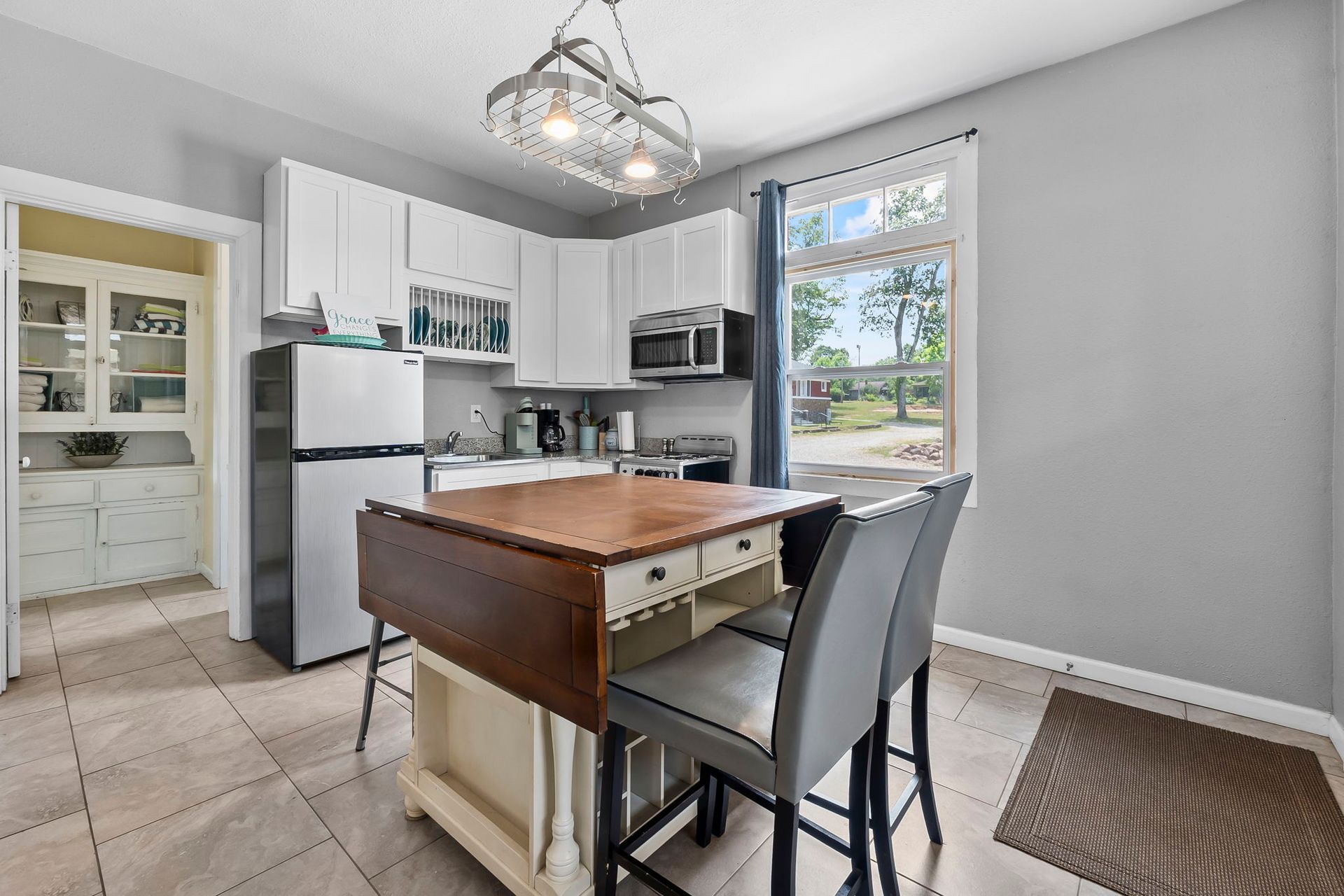 a kitchen with a table and chairs and a refrigerator .