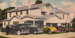 Vintage house with three classic cars parked in front, including black, yellow, and red vehicles.