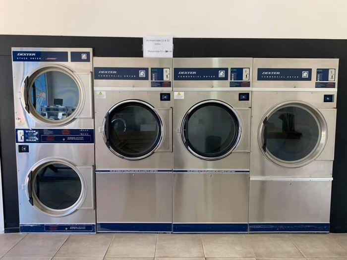 Row of Stainless Steel Commercial Laundry Dryers — Flynns Beach Service Laundry in Port Macquarie, NSW