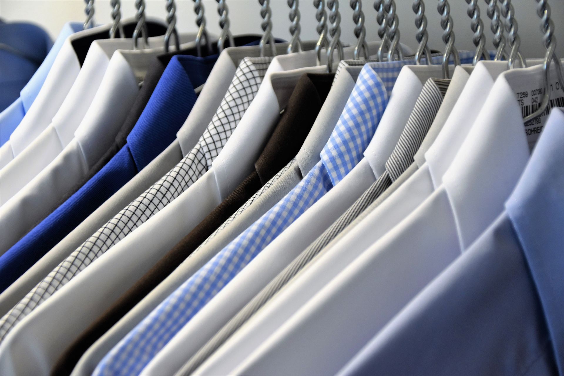 Close-up of a Row of Dress Shirts Hanging on a Rack — Flynns Beach Service Laundry in Port Macquarie, NSW