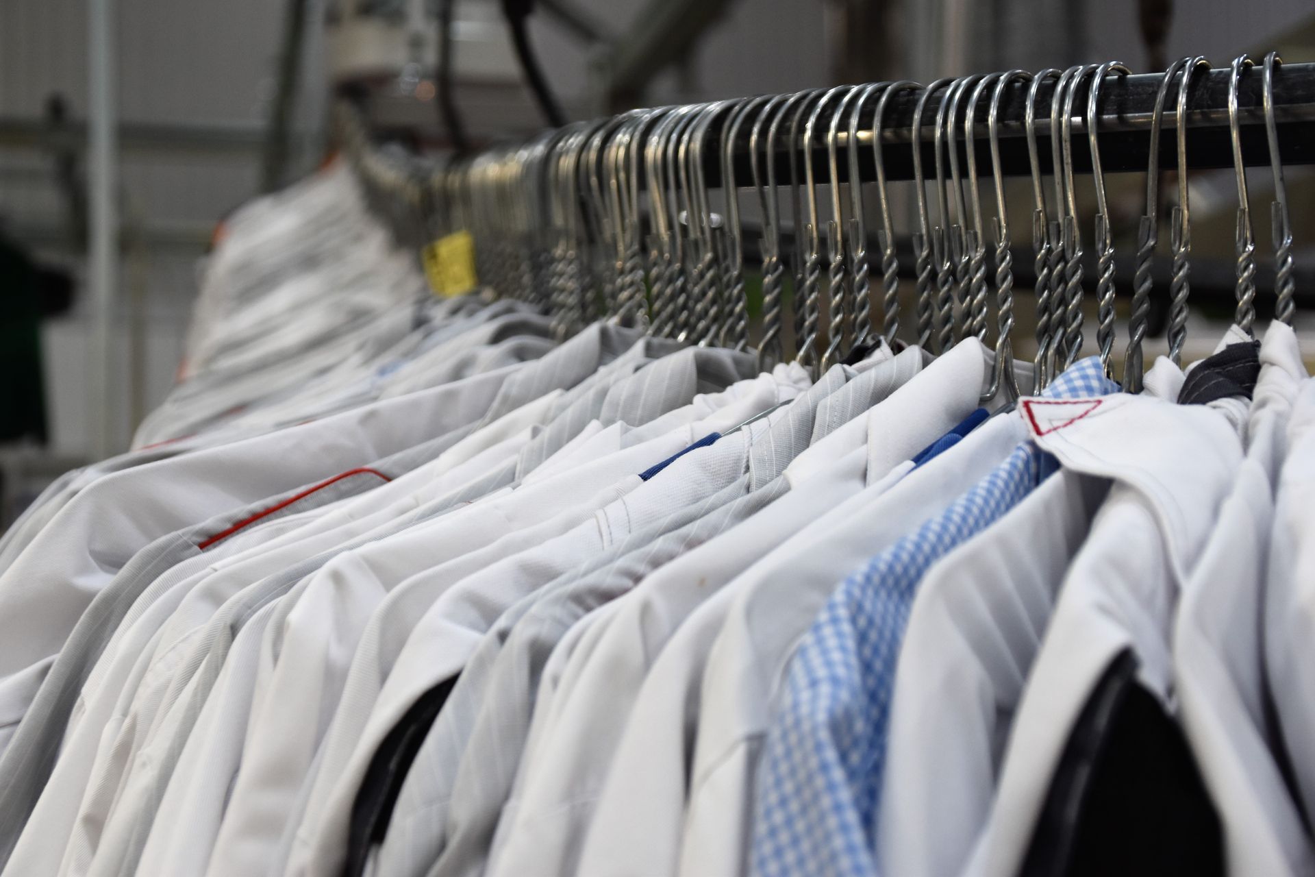 Row of White Button-down Shirts Hanging on a Metal Rack— Flynns Beach Service Laundry in Port Macquarie, NSW