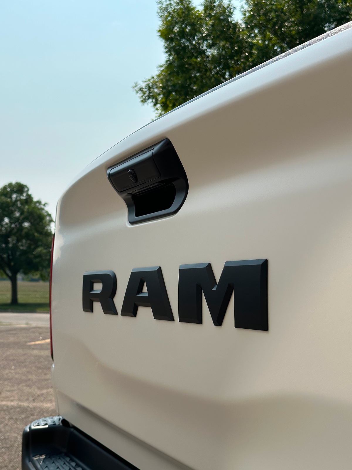 Close-up of a white Ram truck tailgate with black