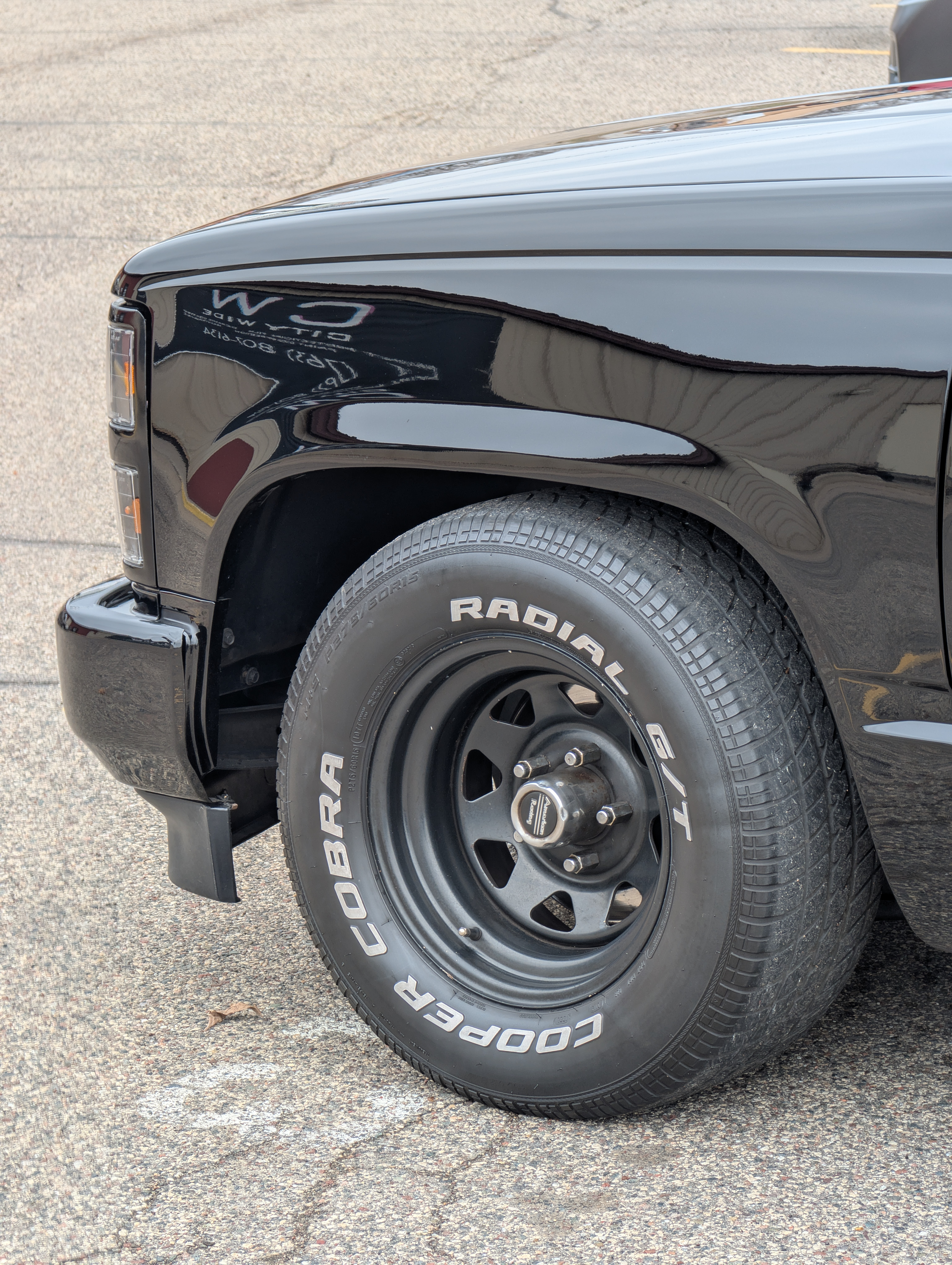 Black pickup truck with black wheels and Cooper Cobra Radial G/T tires.