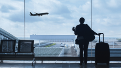Traveler with suitcase near calendar, map pin, and airplane, suggesting trip planning.