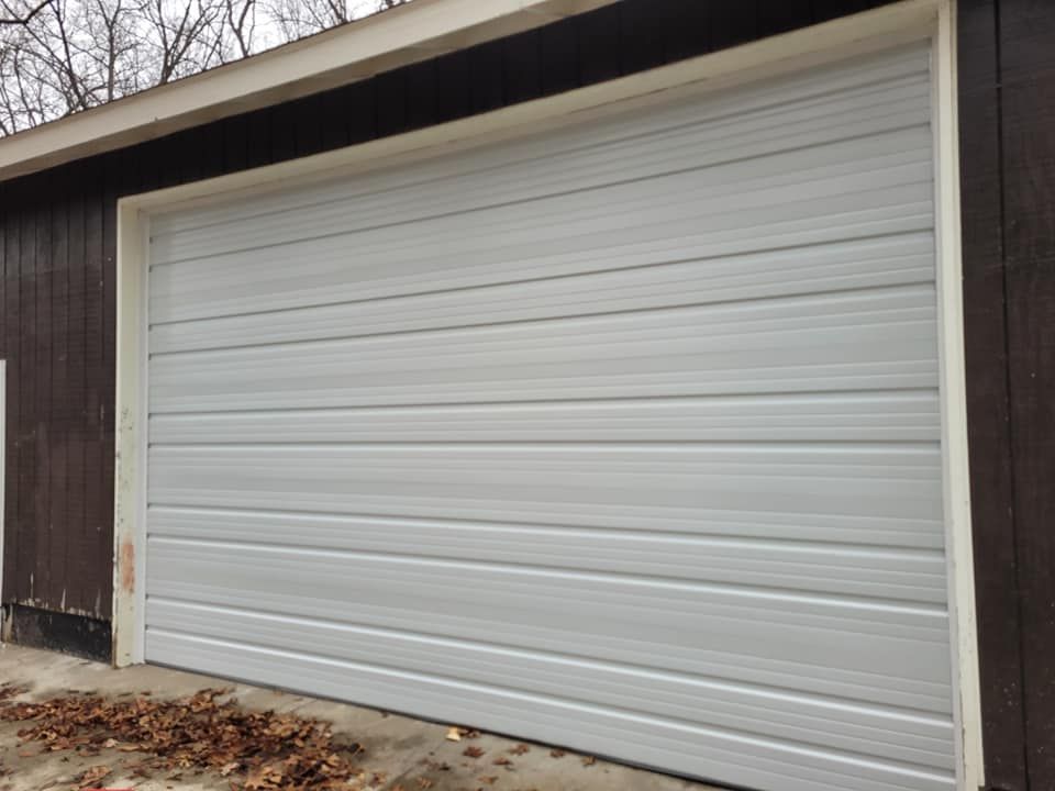 Closed brown garage door with a concrete driveway in front