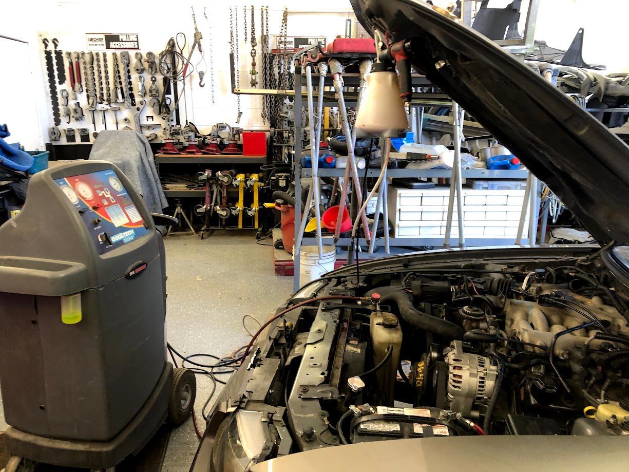 Car wired to an machine for A/C auto repairs.