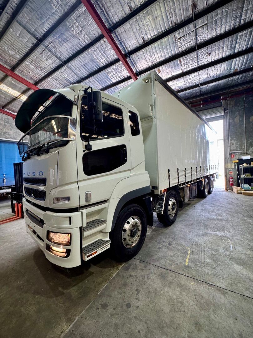 A Row of Semi Trucks Are Parked in a Parking Lot — Inline Truck and Plant in Tuggerah, NSW