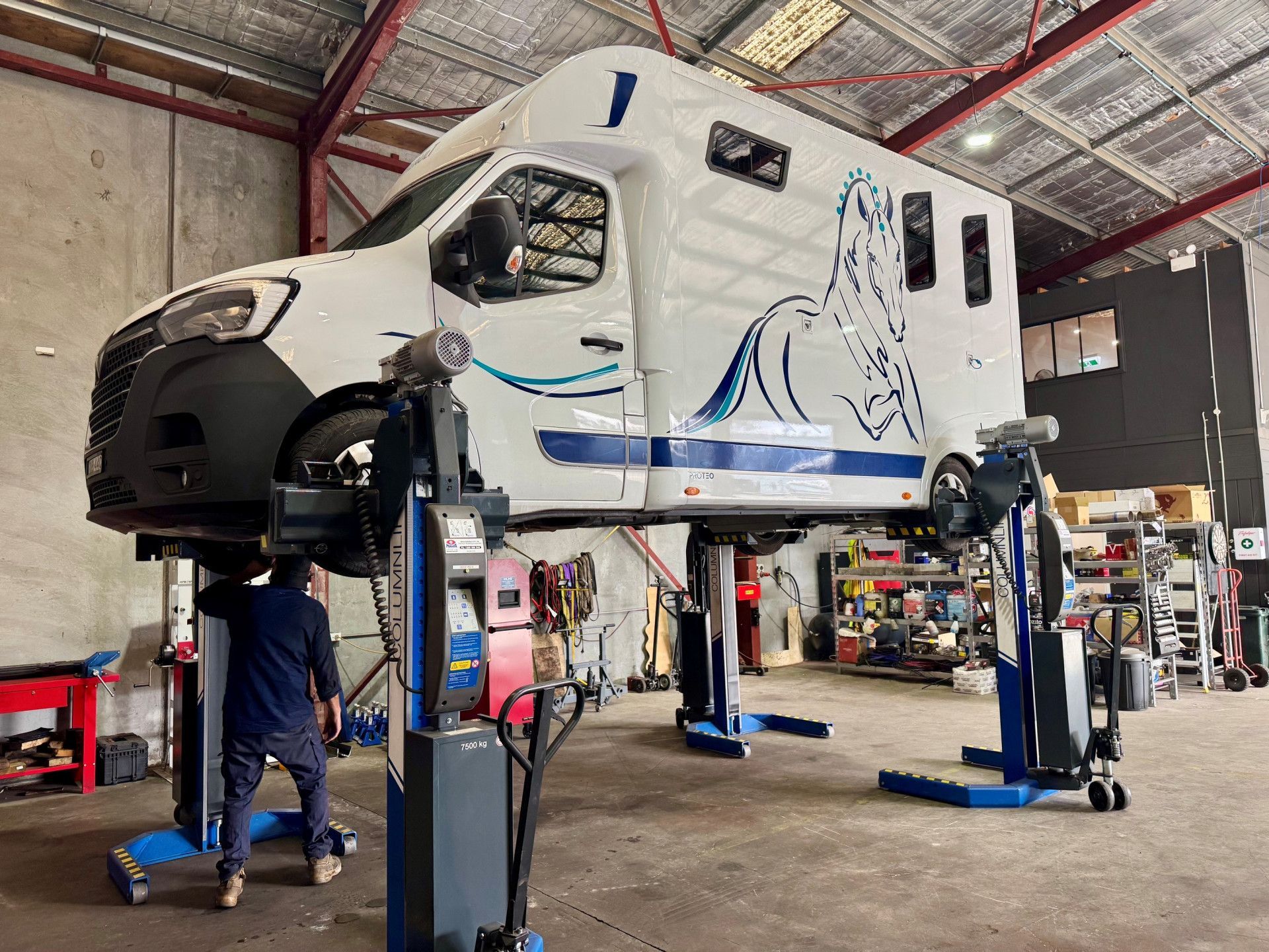 A Truck is Sitting on a Lift in a Garage — Inline Truck and Plant in Tuggerah, NSW