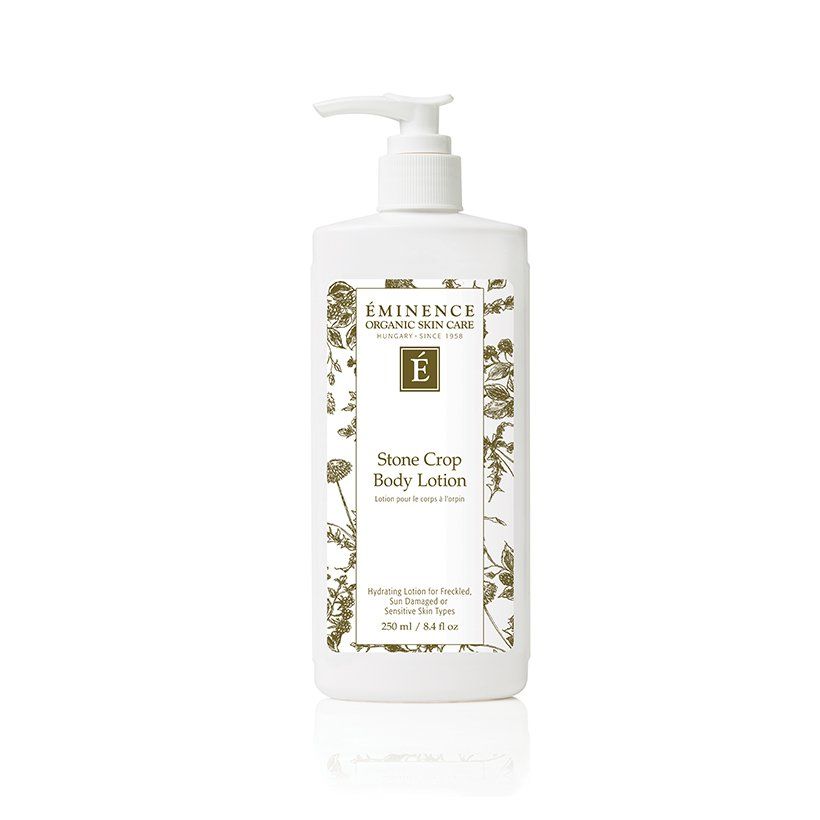A bottle of body lotion with a pump on a white background.