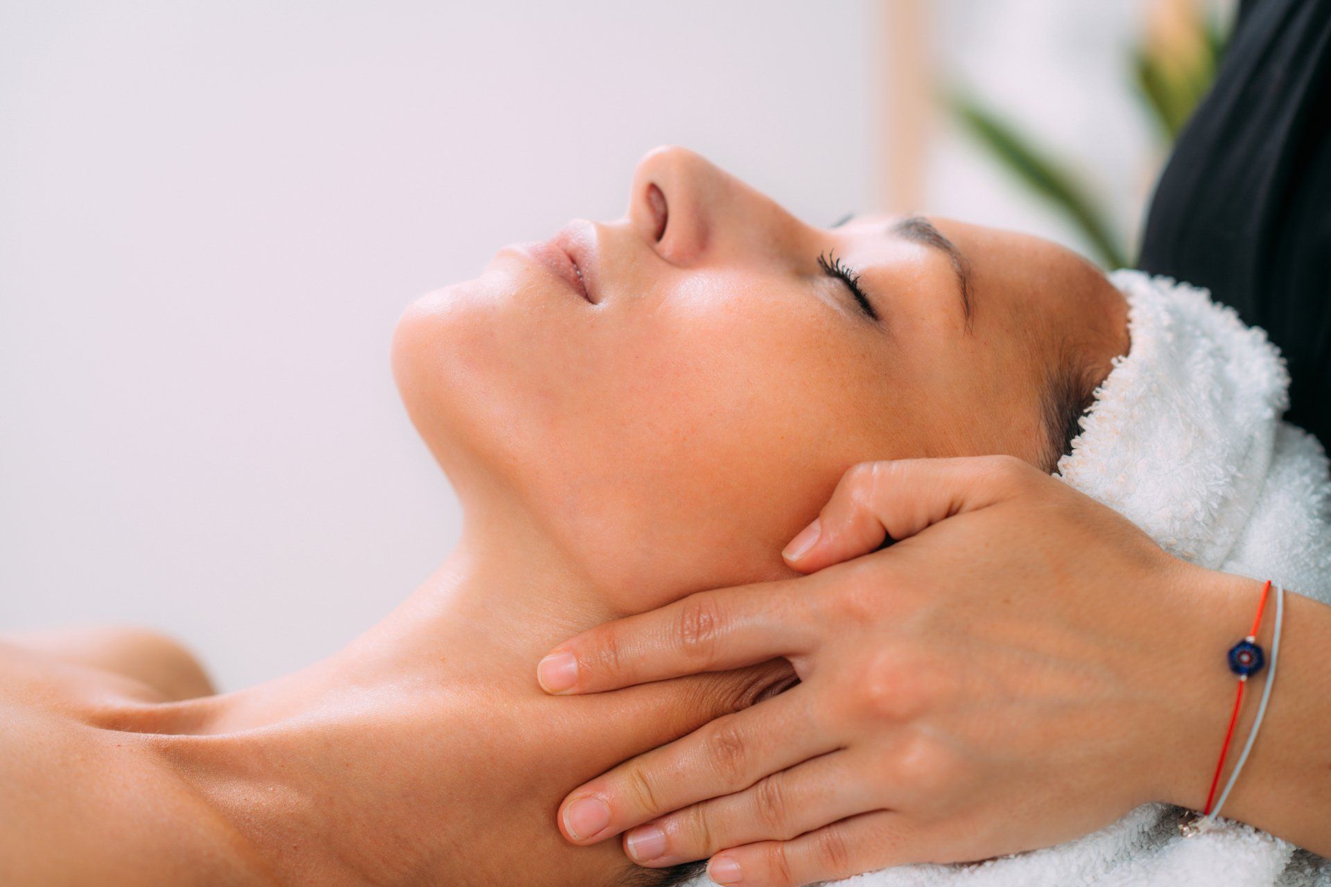 A woman is getting a massage on her face in a spa.