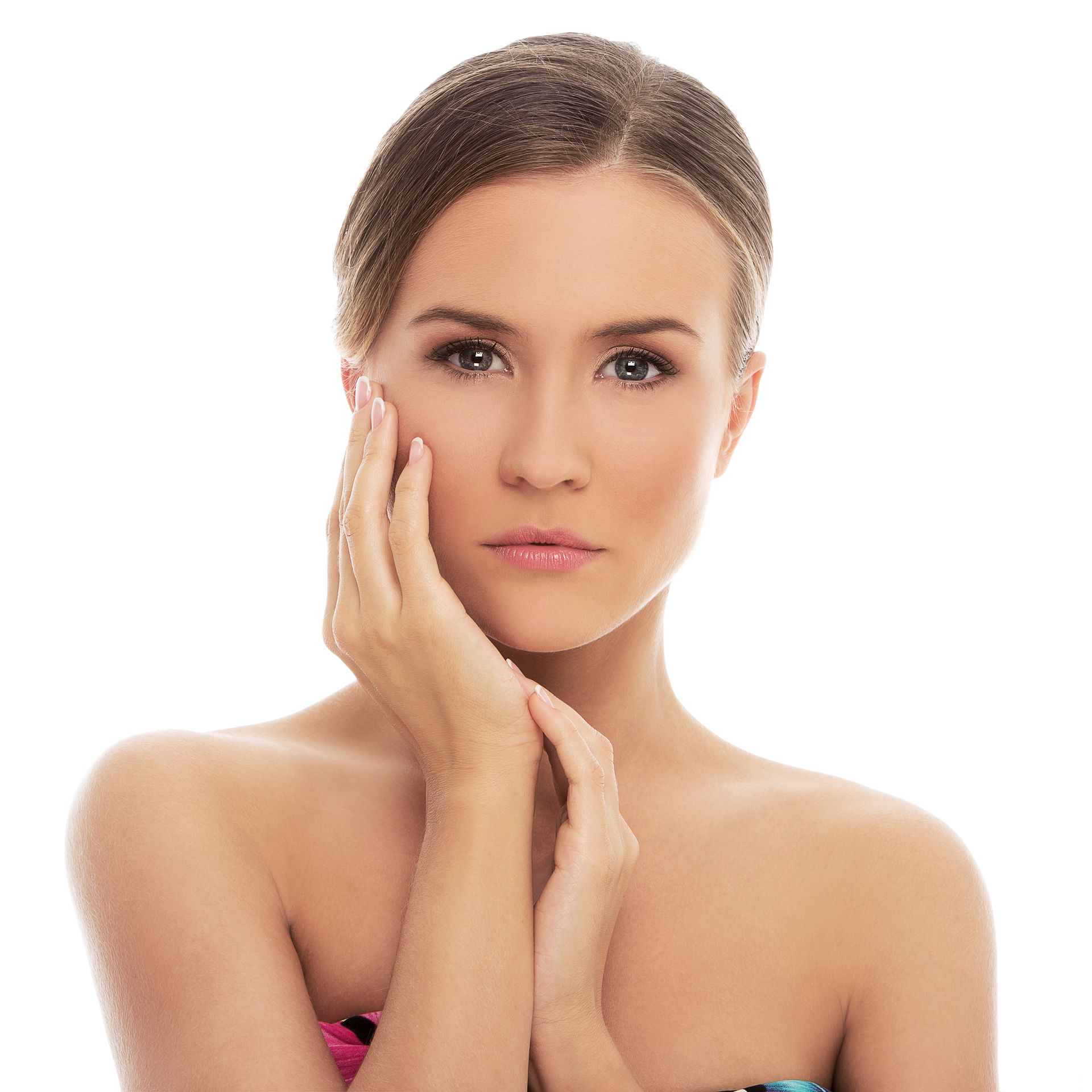 A woman with her hand on her face looks at the camera