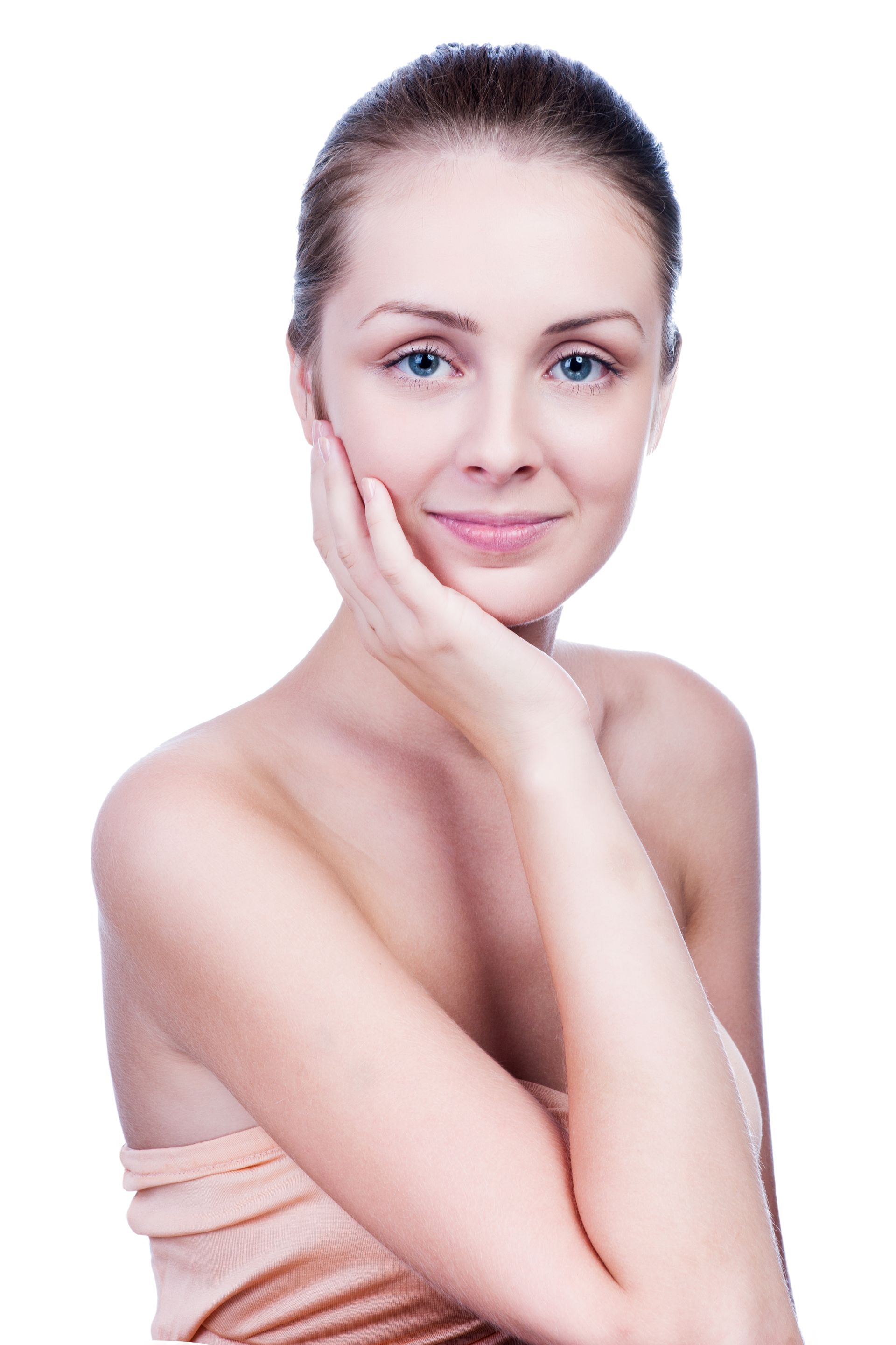 A woman is touching her face with her hand and smiling.