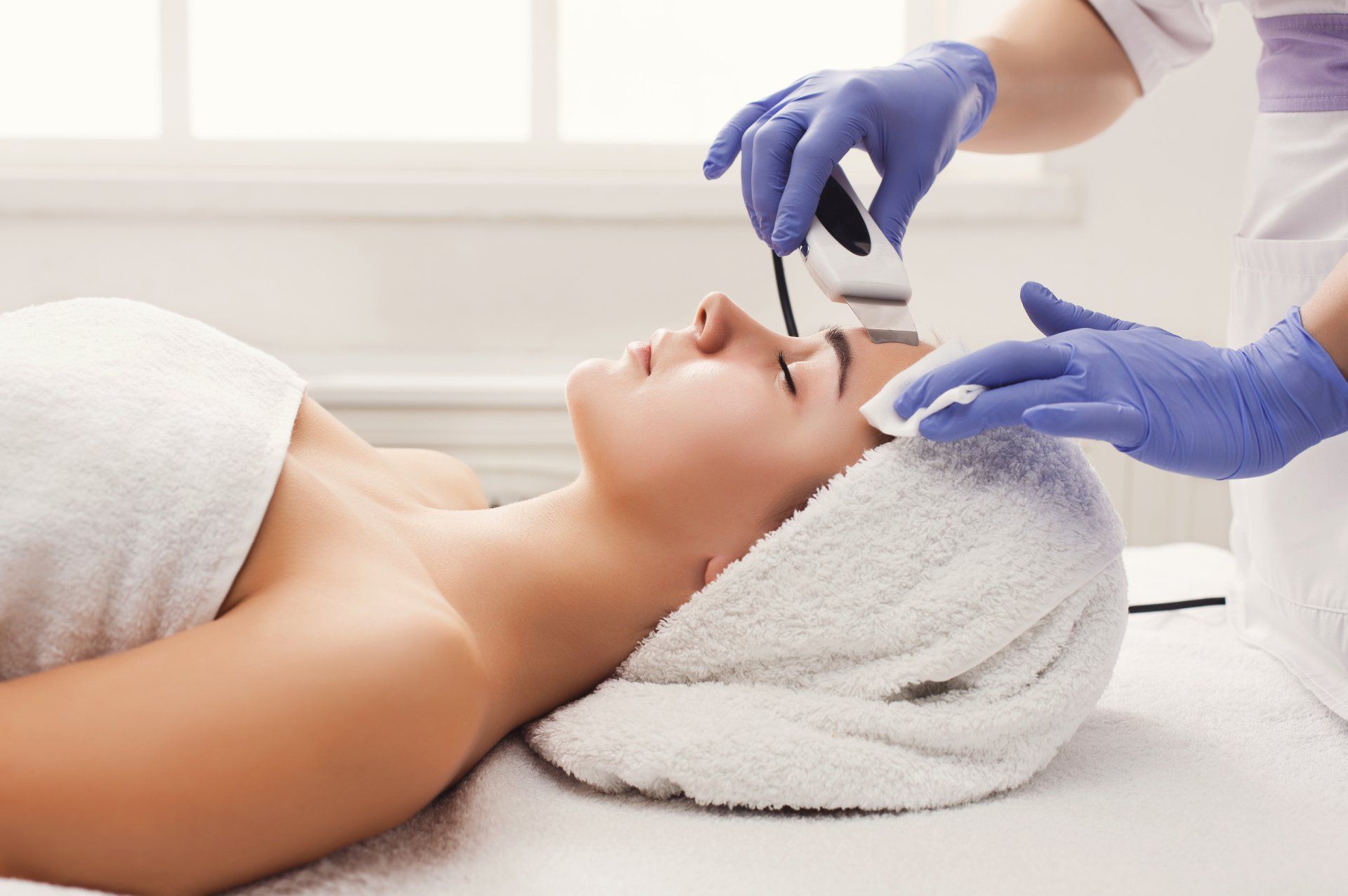 A woman is getting a facial treatment at a spa.