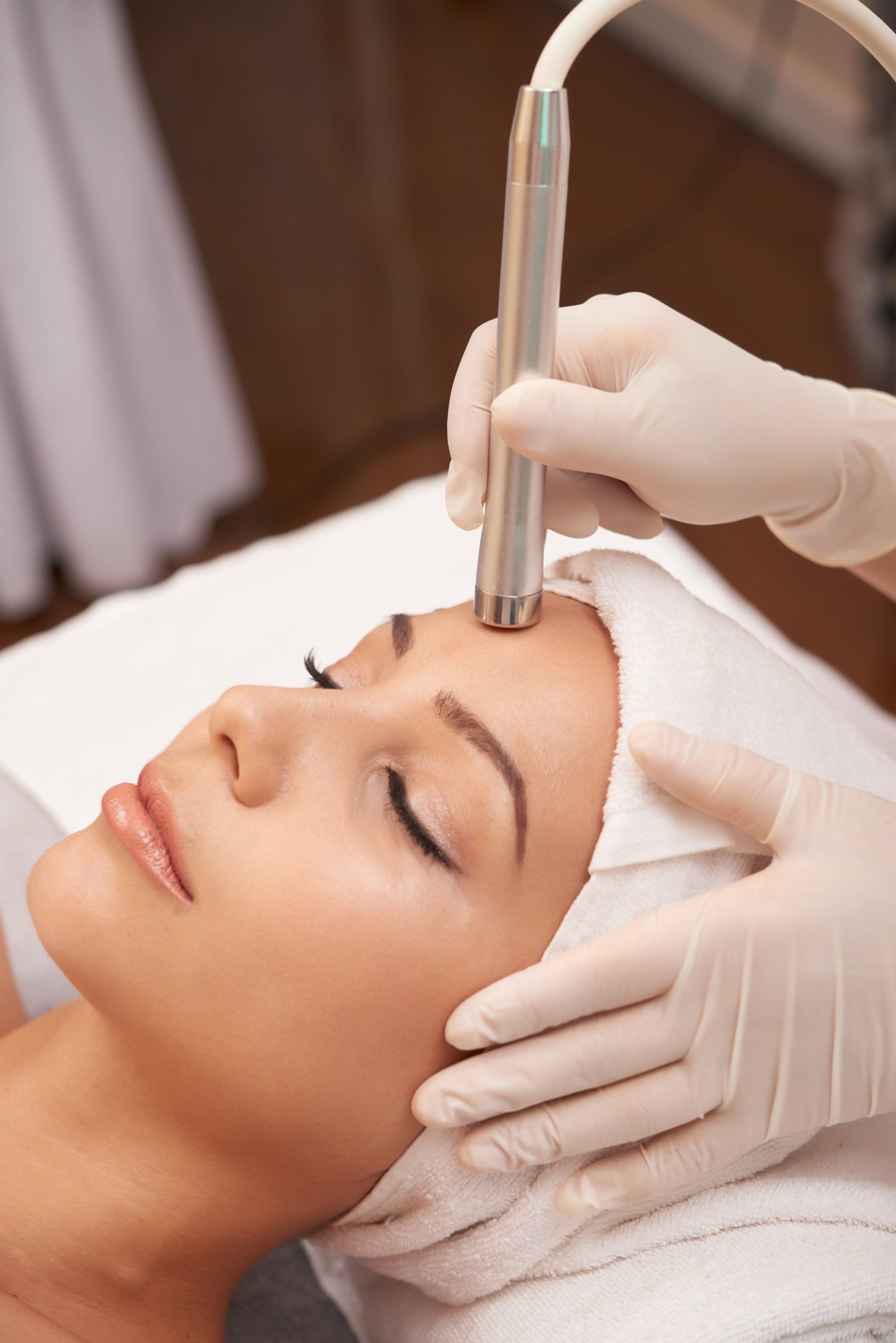 A woman is getting a facial treatment at a spa.