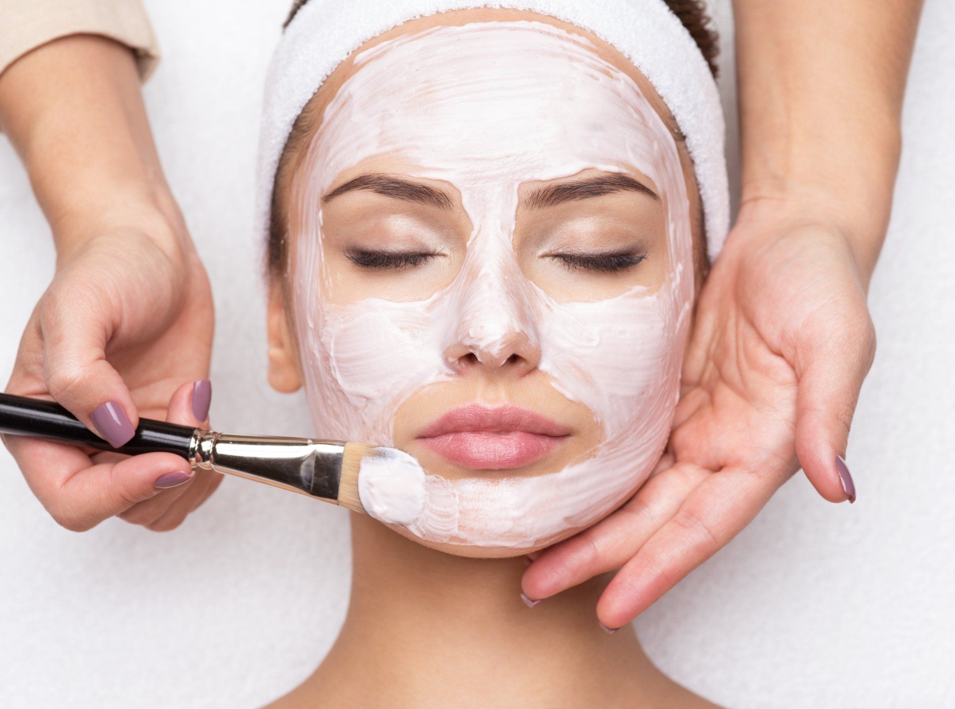 A woman is getting a facial treatment at a spa.