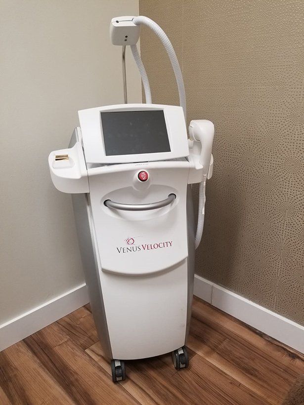 A machine is sitting on a wooden floor in a room.