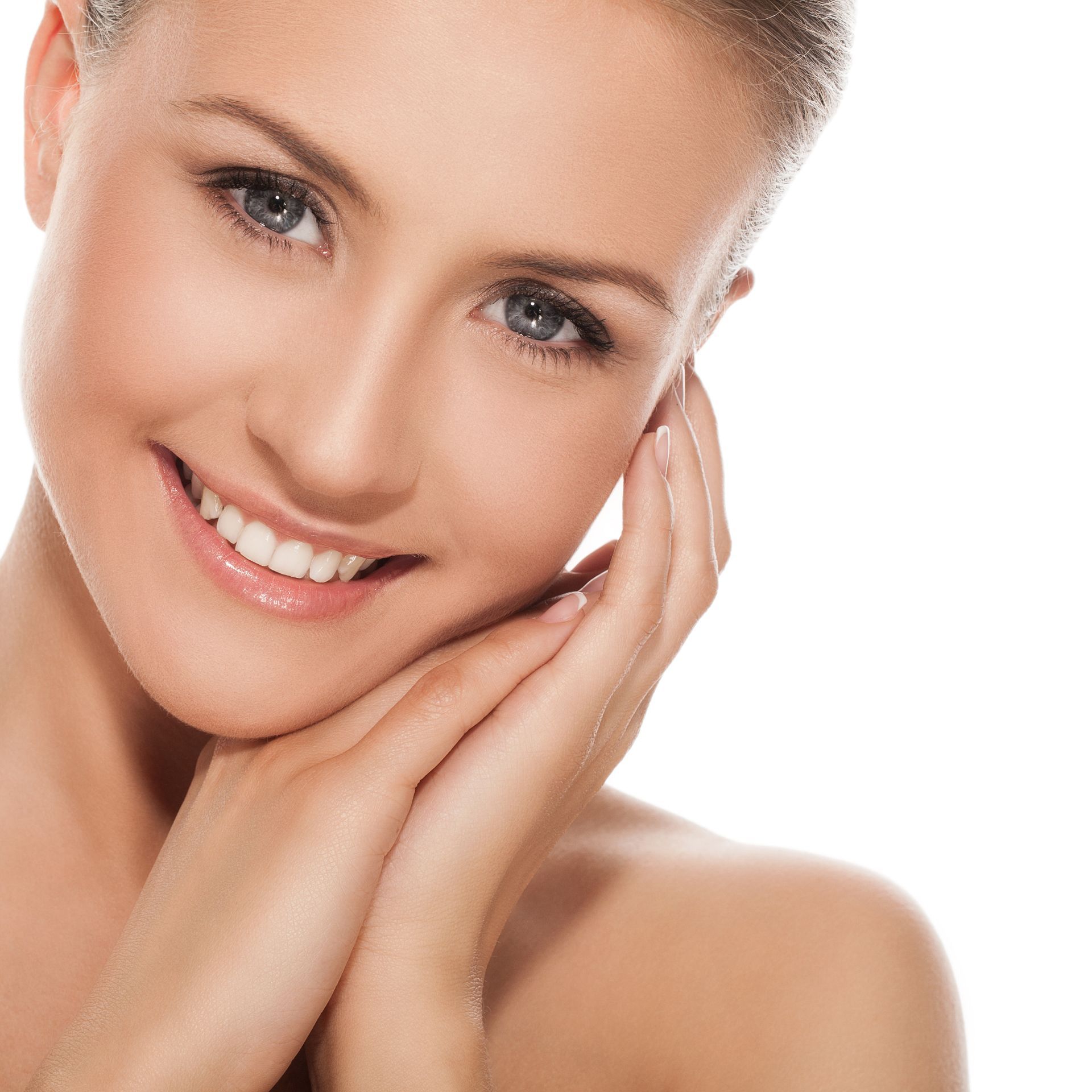 A woman is smiling and touching her face with her hands